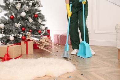 Photo of Person from cleaning service working in messy room after New Year party, closeup