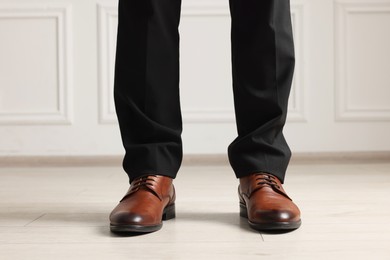 Photo of Businessman in elegant leather shoes indoors, closeup