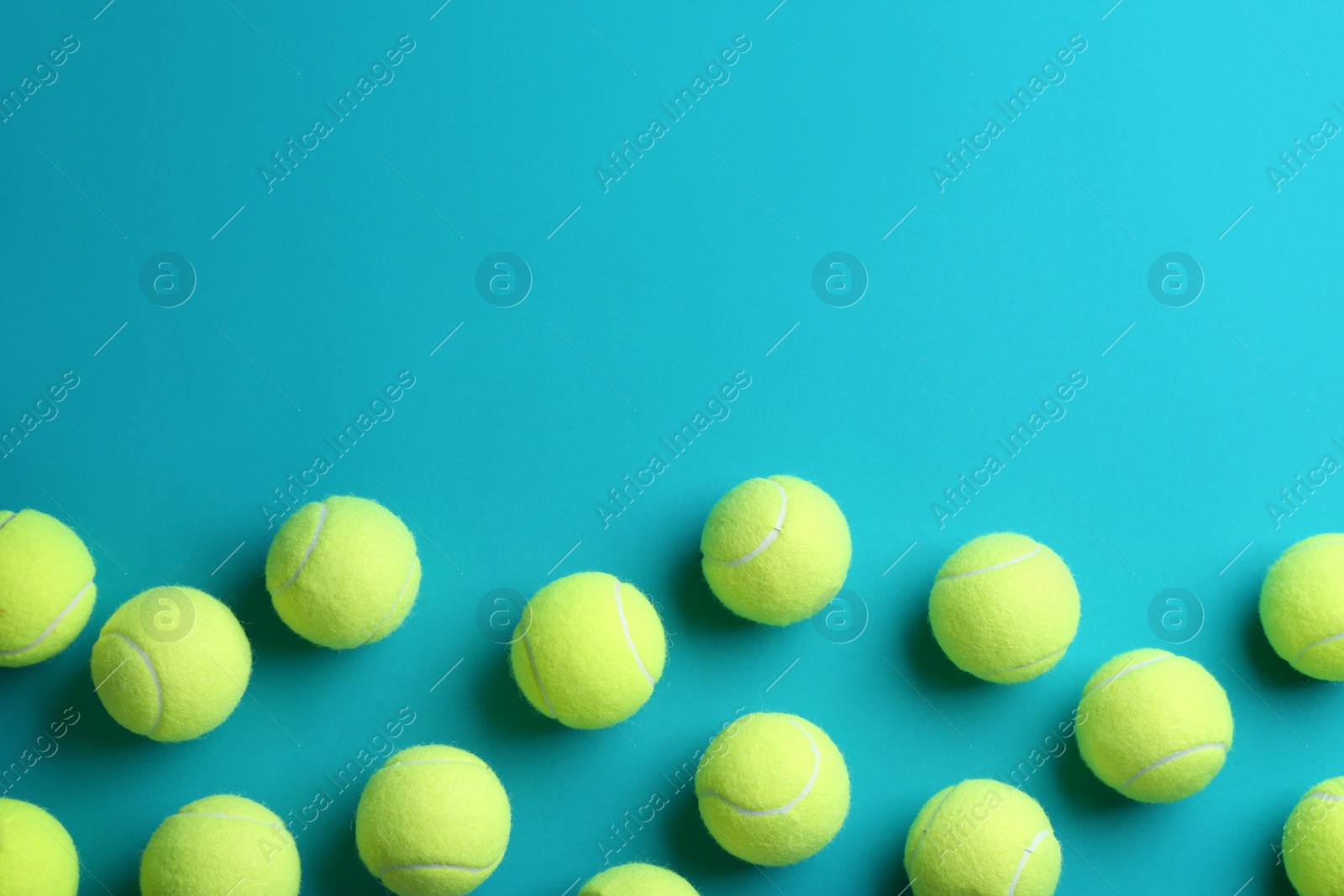 Photo of Tennis balls on blue background, flat lay. Space for text