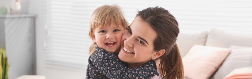 Mother and her little daughter spending time together at home, banner design