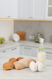 Photo of Allergenic food. Different fresh products on light marble table in kitchen