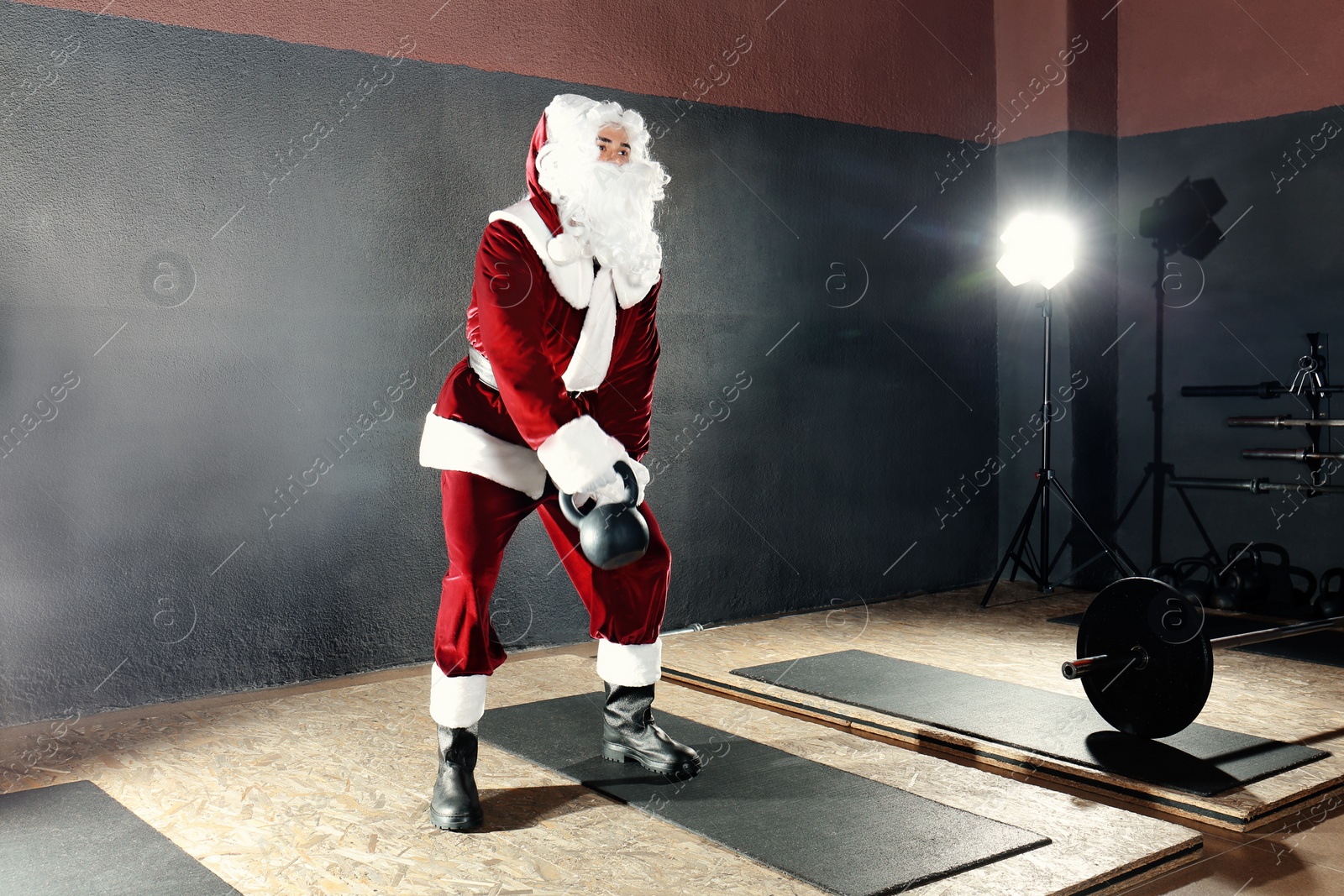 Photo of Young Santa Claus training in modern gym