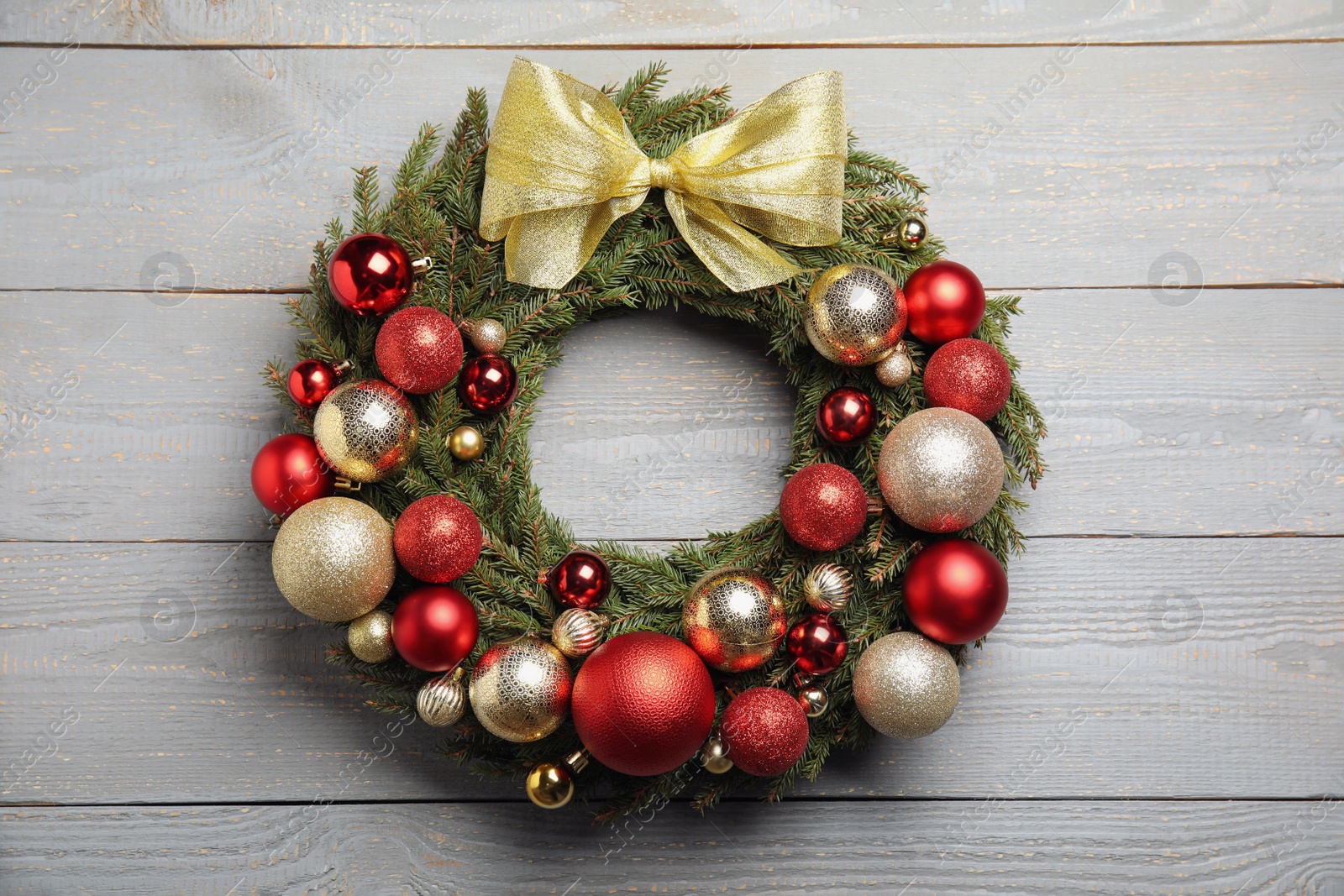 Photo of Beautiful Christmas wreath with festive decor on white wooden background