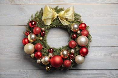 Photo of Beautiful Christmas wreath with festive decor on white wooden background
