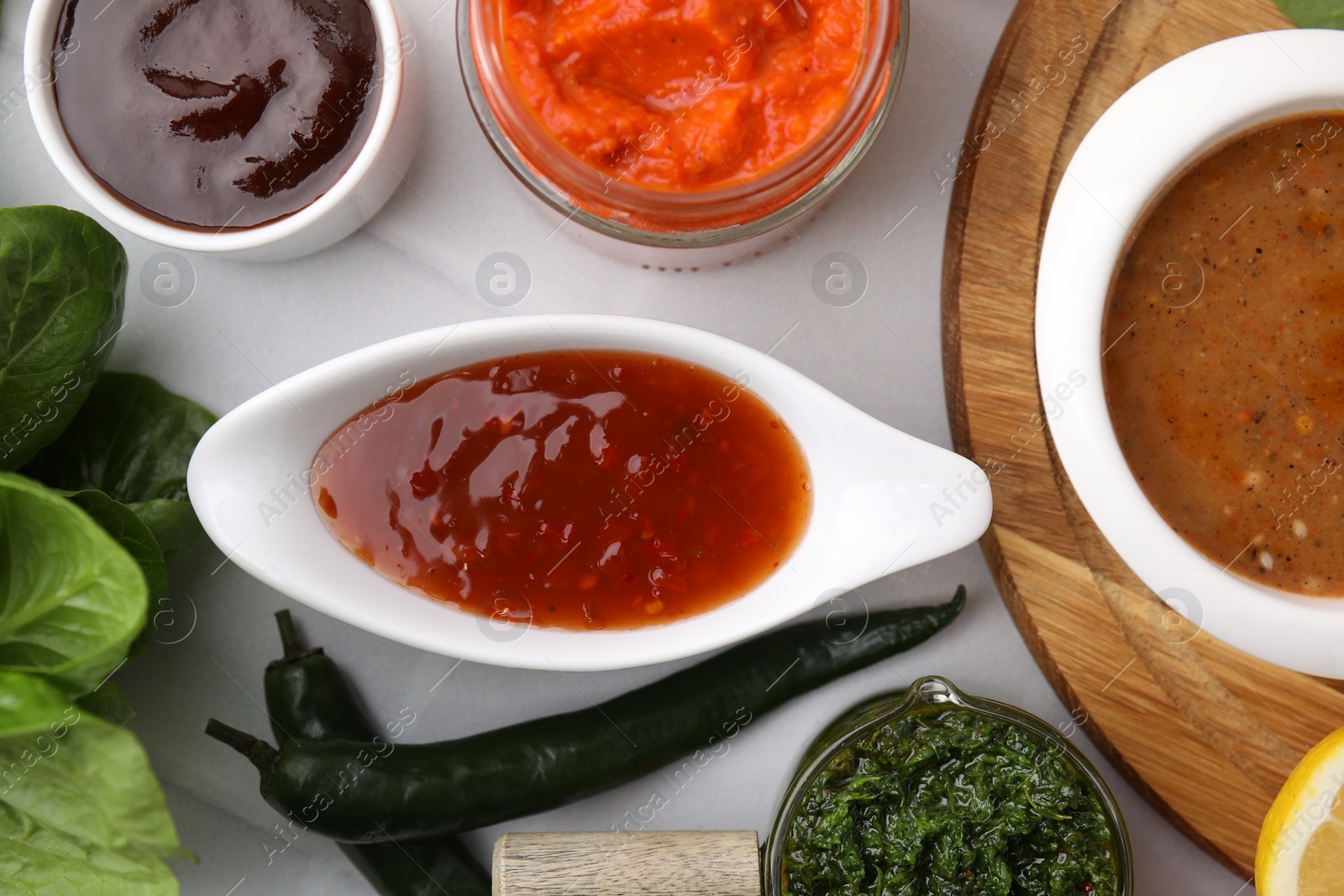 Photo of Different marinades on white table, flat lay