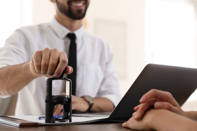 Male notary working with client in office, closeup