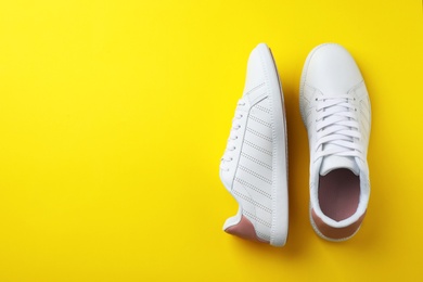 Photo of Pair of sneakers on color background, flat lay. Space for text