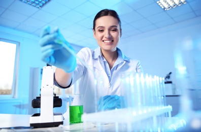 Photo of Female scientist working with sample in modern chemistry laboratory