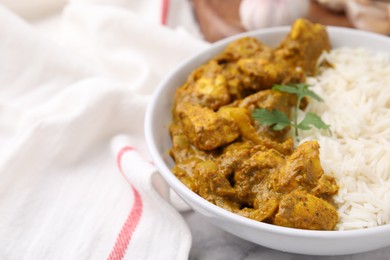 Photo of Delicious chicken curry with rice on table, closeup. Space for text