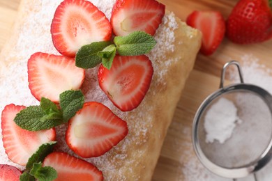 Delicious cake roll with strawberries and mint on table, top view