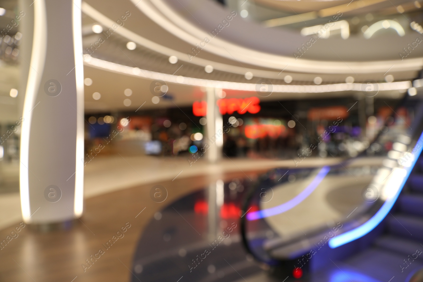 Photo of Blurred view of modern shopping mall interior. Bokeh effect