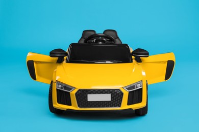 Photo of Child's electric toy car on light blue background