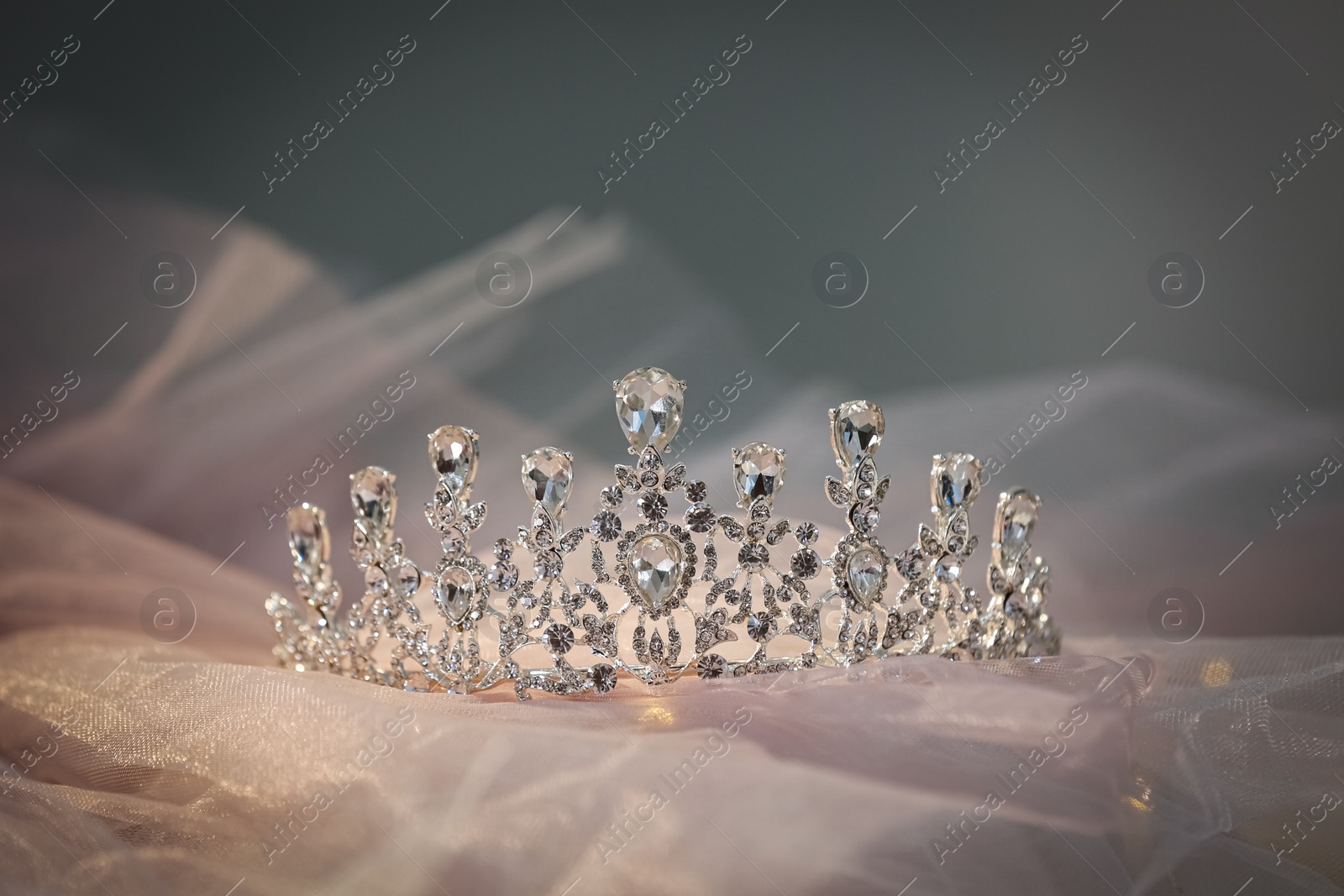 Photo of Beautiful silver tiara with diamonds on light cloth