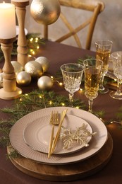 Photo of Table setting with festive lights and Christmas decor