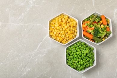 Photo of Flat lay composition with frozen vegetables on light background