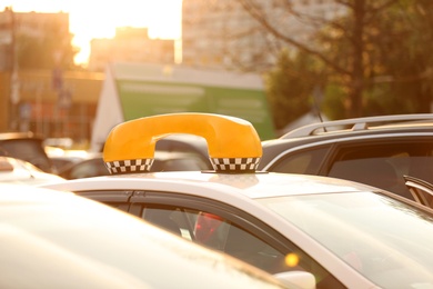 Photo of Parked taxi with tinted windows on city street, closeup