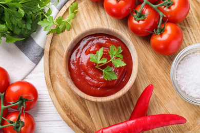 Flat lay composition with tomato sauce on white wooden table