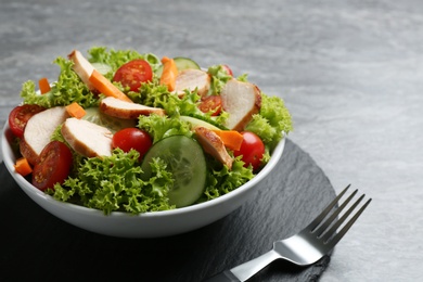 Delicious fresh chicken salad served on grey table, closeup