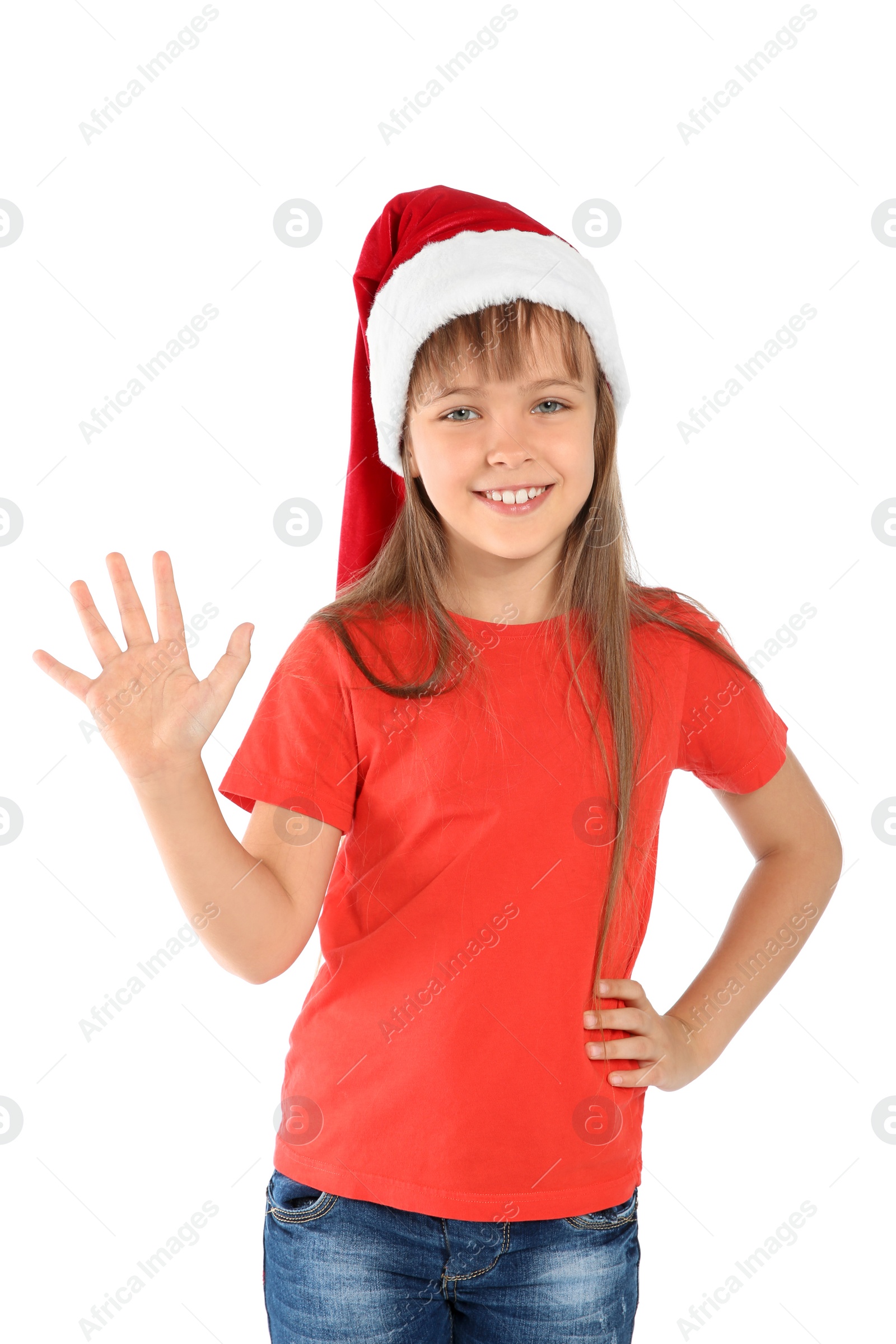 Photo of Cute little child in Santa hat on white background. Christmas celebration