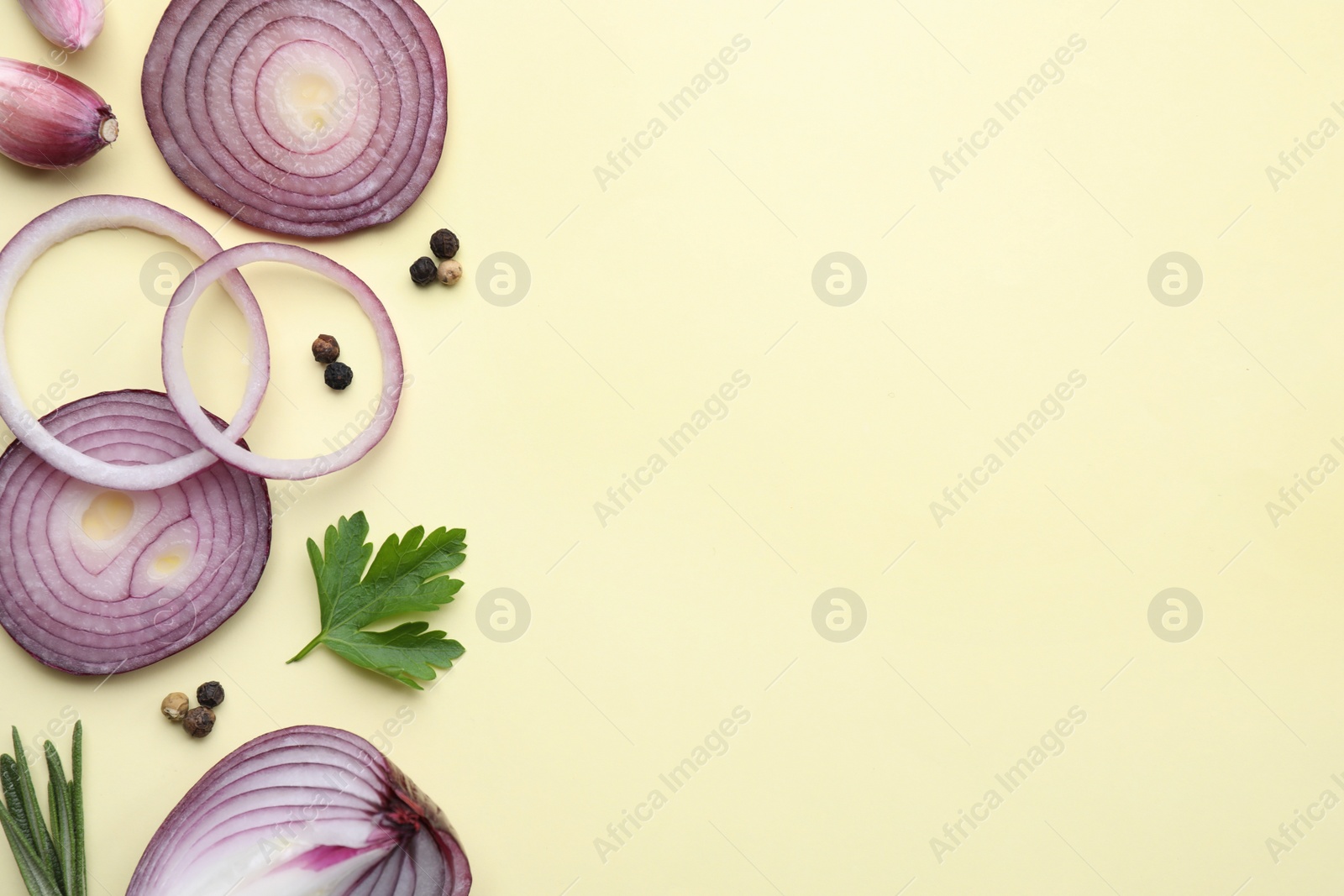 Photo of Flat lay composition with onion and spices on beige background. Space for text