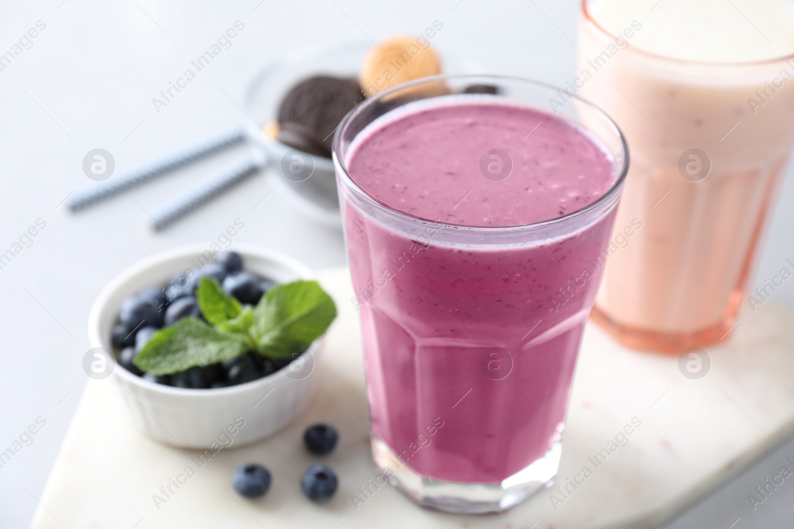 Photo of Tasty milk shake in glass on table