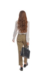 Young woman in casual outfit with black bag walking on white background, back view