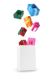 Image of Many different gift boxes falling into paper shopping bag on white background