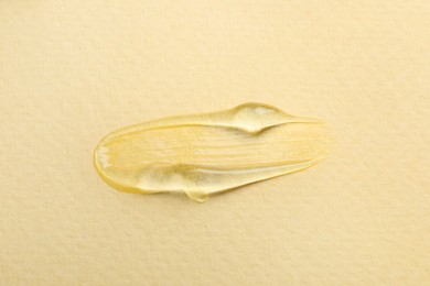 Sample of transparent gel on yellow background, top view