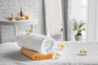 Photo of Towels on massage table in spa salon