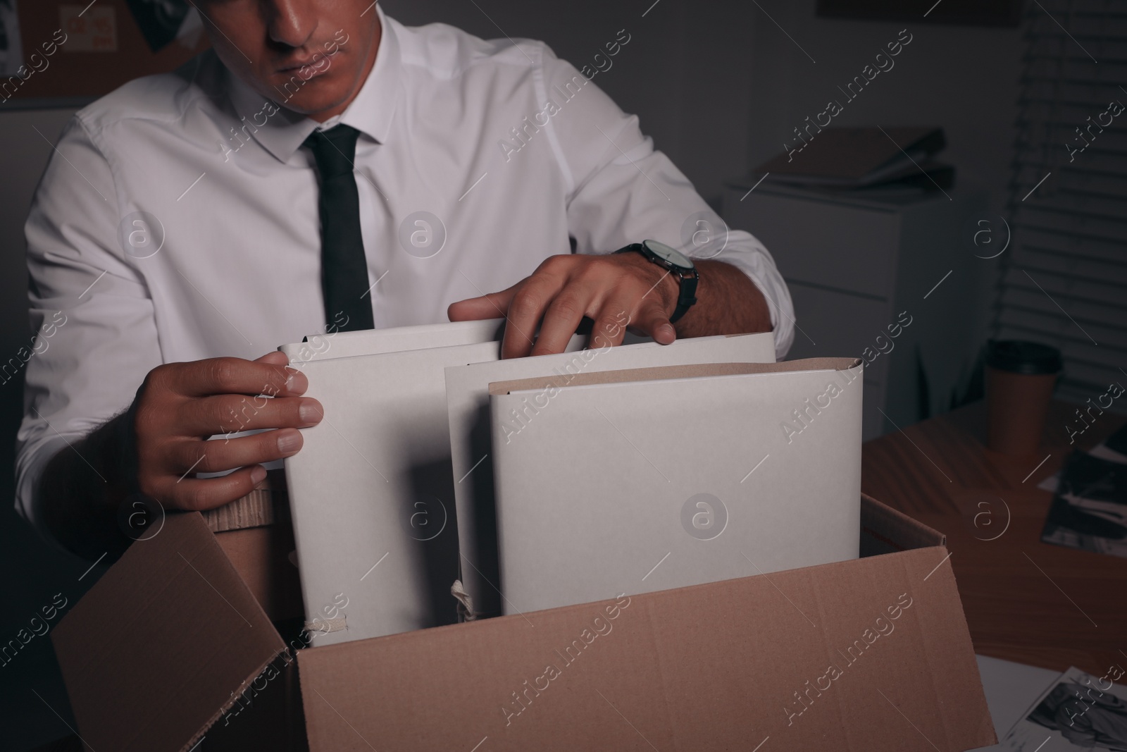 Photo of Professional detective doing paperwork in his office, closeup