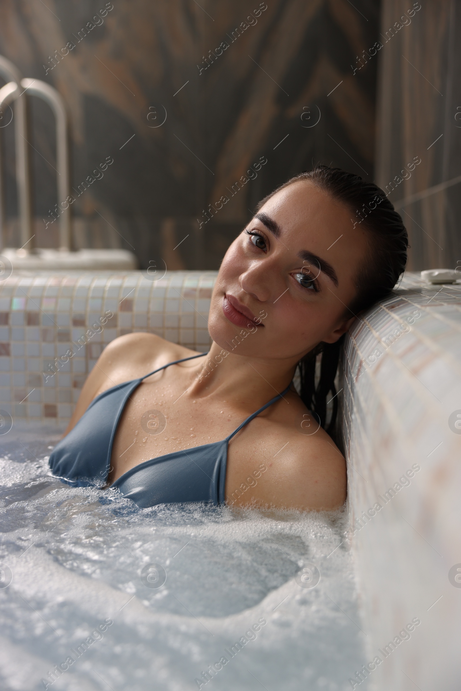 Photo of Beautiful woman relaxing in spa swimming pool