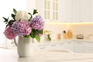 Photo of Bouquet with beautiful hydrangea flowers on white marble table. Space for text