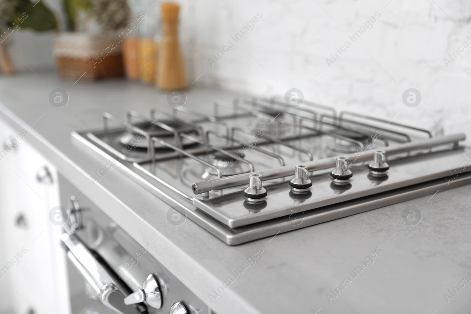 Photo of New modern stove with gas burners in kitchen, closeup