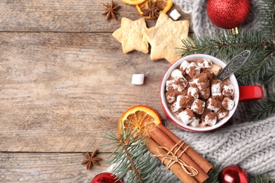Photo of Flat lay composition of tasty cocoa with marshmallows on wooden table. Space for text