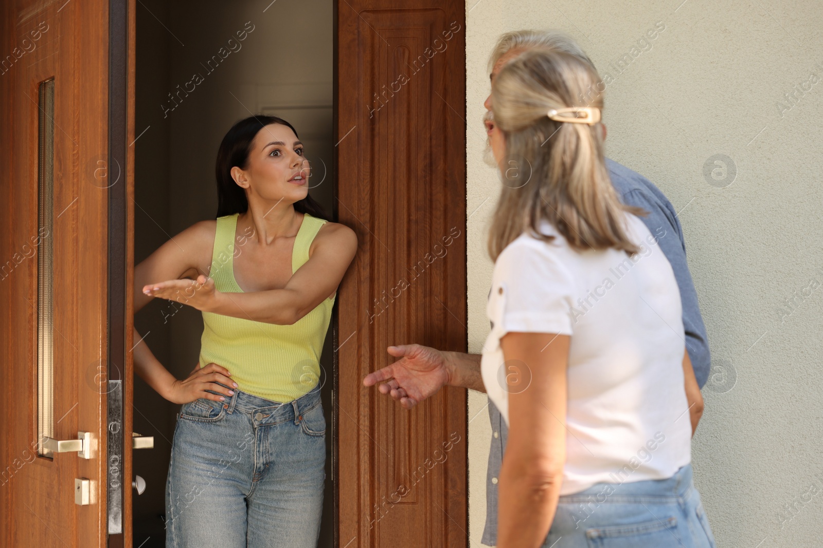 Photo of Neighbour`s quarrel. Elderly couple arguing with emotional woman