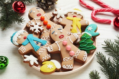 Photo of Delicious Christmas cookies and festive decor on white wooden table