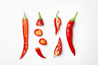 Photo of Fresh red chili peppers on white background, top view