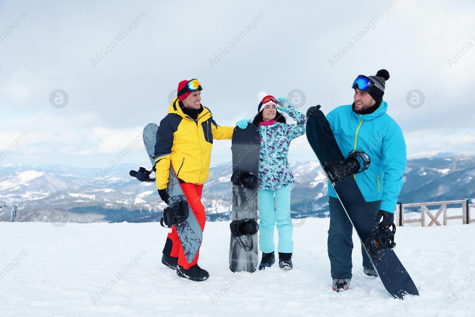 Photo of Group of friends with equipment in snowy mountains. Winter vacation