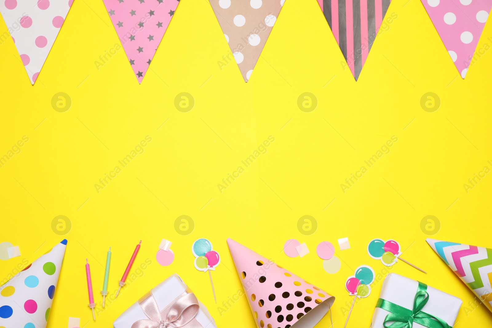 Photo of Flat lay composition with party decor on yellow background. Space for text