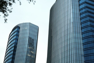 Photo of Low angle view of modern buildings with many windows against clear sky