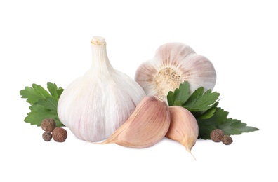 Photo of Fresh garlic bulbs and cloves with seasonings on white background. Organic food