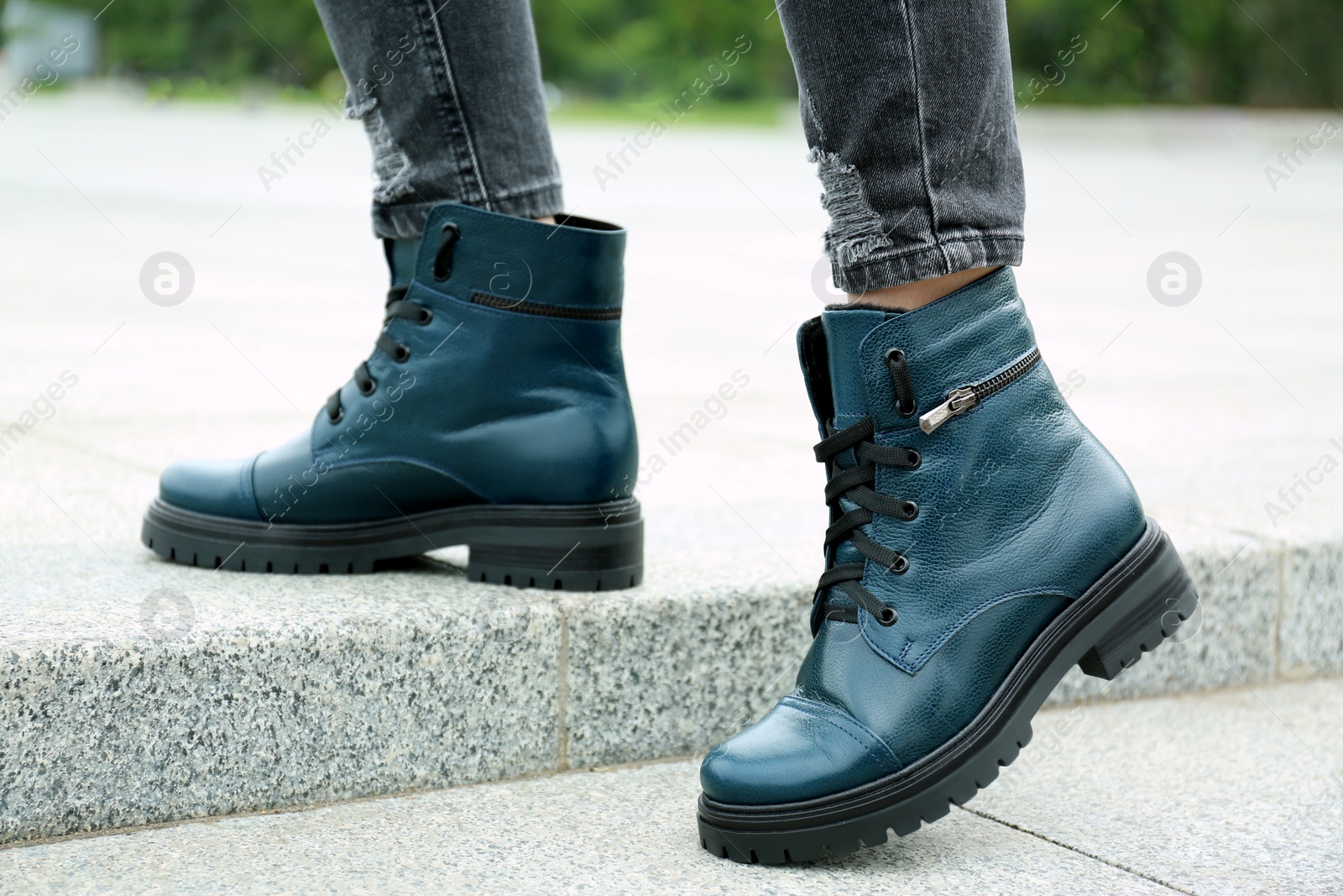 Photo of Woman wearing comfortable stylish boots outdoors, closeup