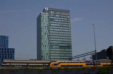 Exterior of beautiful modern skyscraper against blue sky