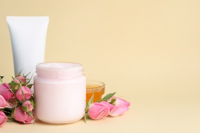 Photo of Different hand care cosmetic products, roses and honey on beige background, space for text