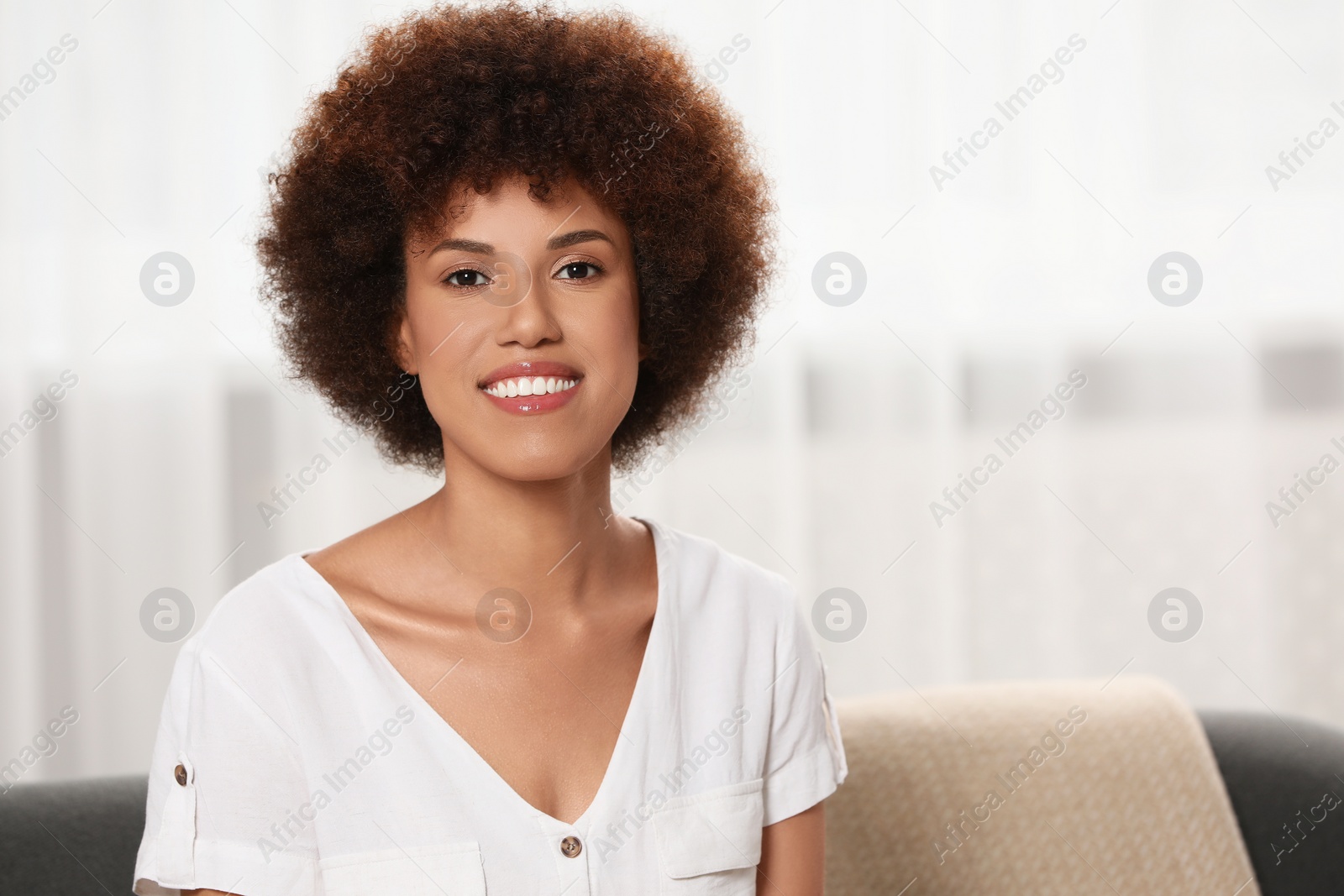 Photo of Portrait of beautiful young woman near window indoors