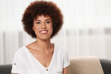 Photo of Portrait of beautiful young woman near window indoors