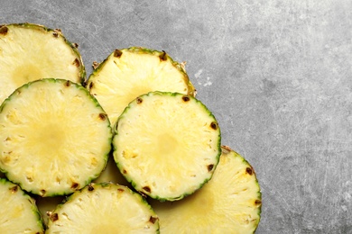 Photo of Fresh sliced pineapple on gray background