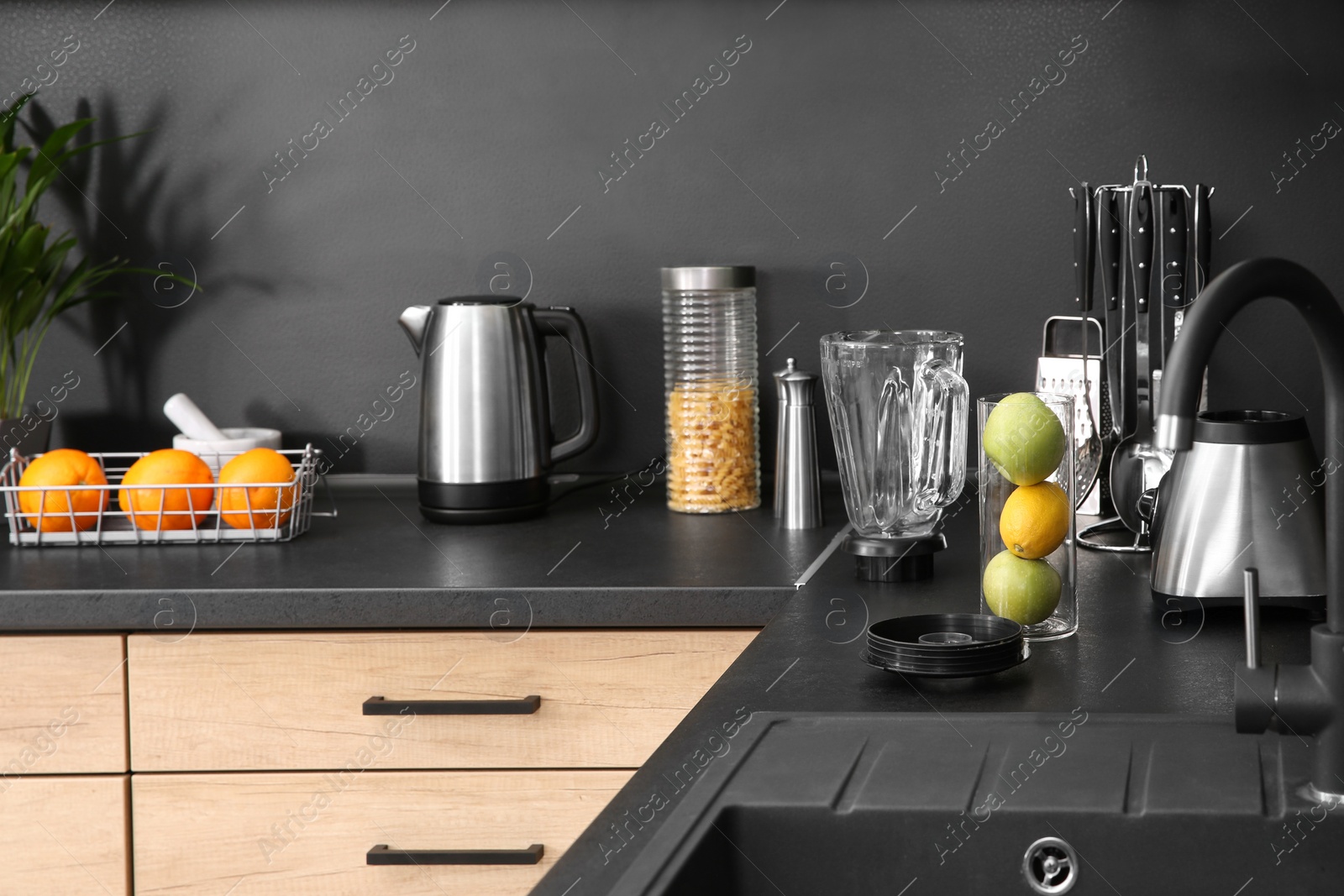 Photo of Stylish kitchen counter with houseware, appliances and products