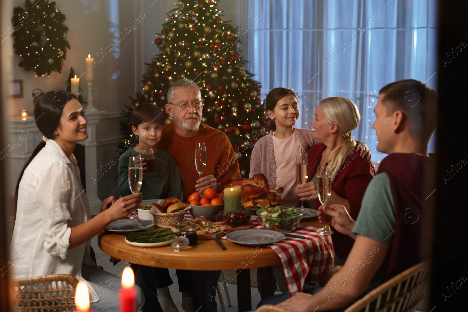 Photo of Happy family enjoying festive dinner at home. Christmas celebration