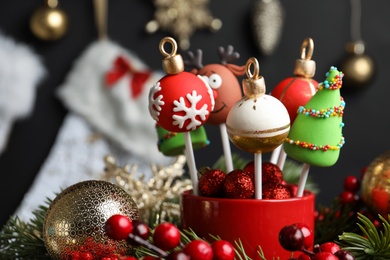 Photo of Delicious Christmas themed cake pops on blurred  background, closeup